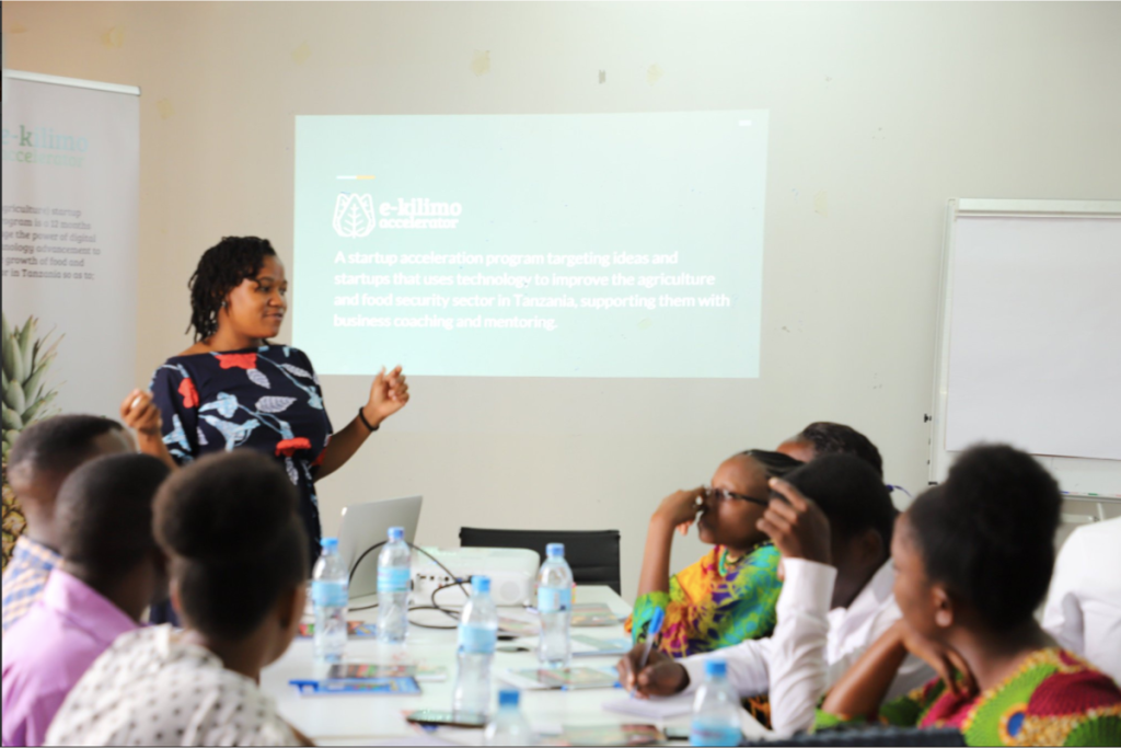 A woman standing in front of a group of participants.